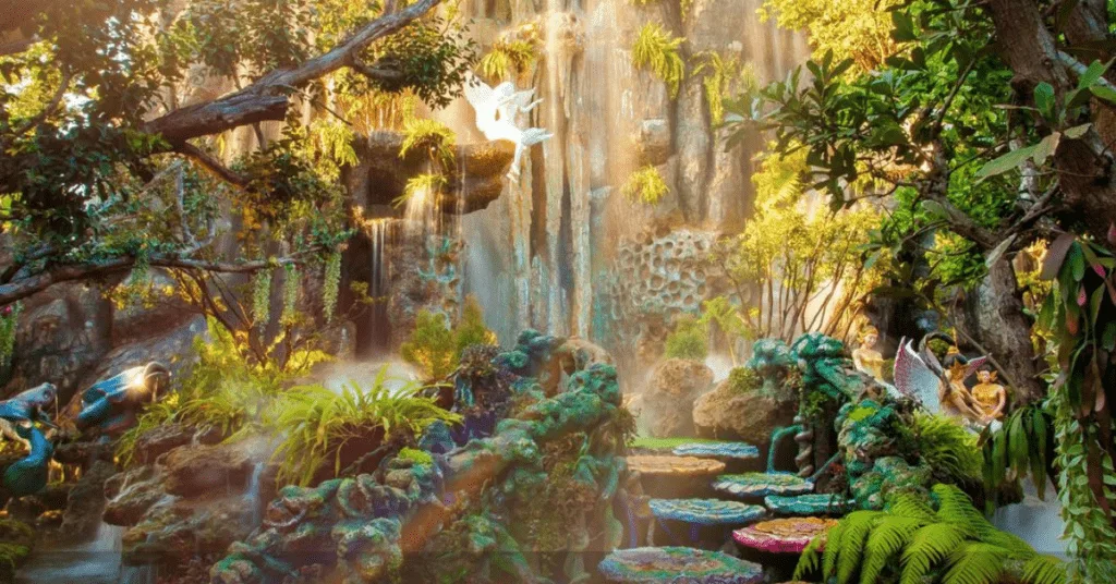 "Lush, vibrant garden scene with cascading waterfalls, colorful foliage, and mystical sculptures at Lalitta Cafe, creating an enchanting and serene atmosphere."