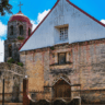 The image shows Lazi Church, also known as San Isidro Labrador Parish Church. It is a historic Roman Catholic church located in Lazi, Siquijor, Philippines. The church is known for its coral stone construction, large wooden convent, and colonial architecture, reflecting its historical and cultural significance in the region.