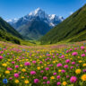 Scenic view of the Valley of Flowers trek in Uttarakhand, India, with vibrant blooming wildflowers in pink, yellow, and blue colors set against lush green hills and snow-capped Himalayan mountains under a clear blue sky