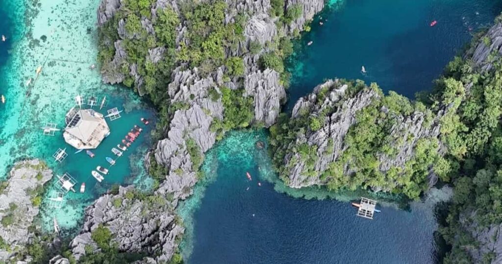 Aerial view of turquoise lake and rocks.